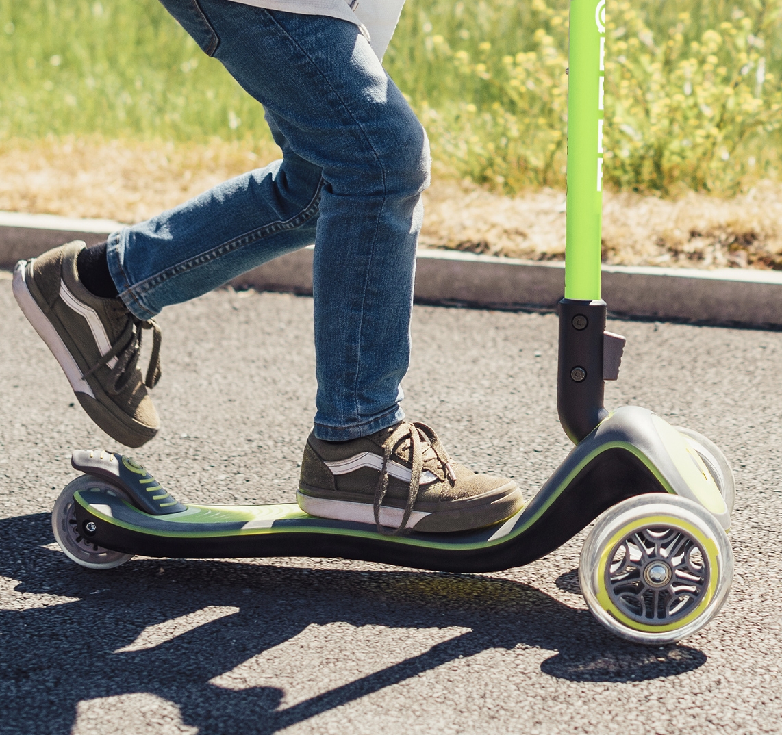 Green light-up scooter for kids with an extra-wide scooter deck