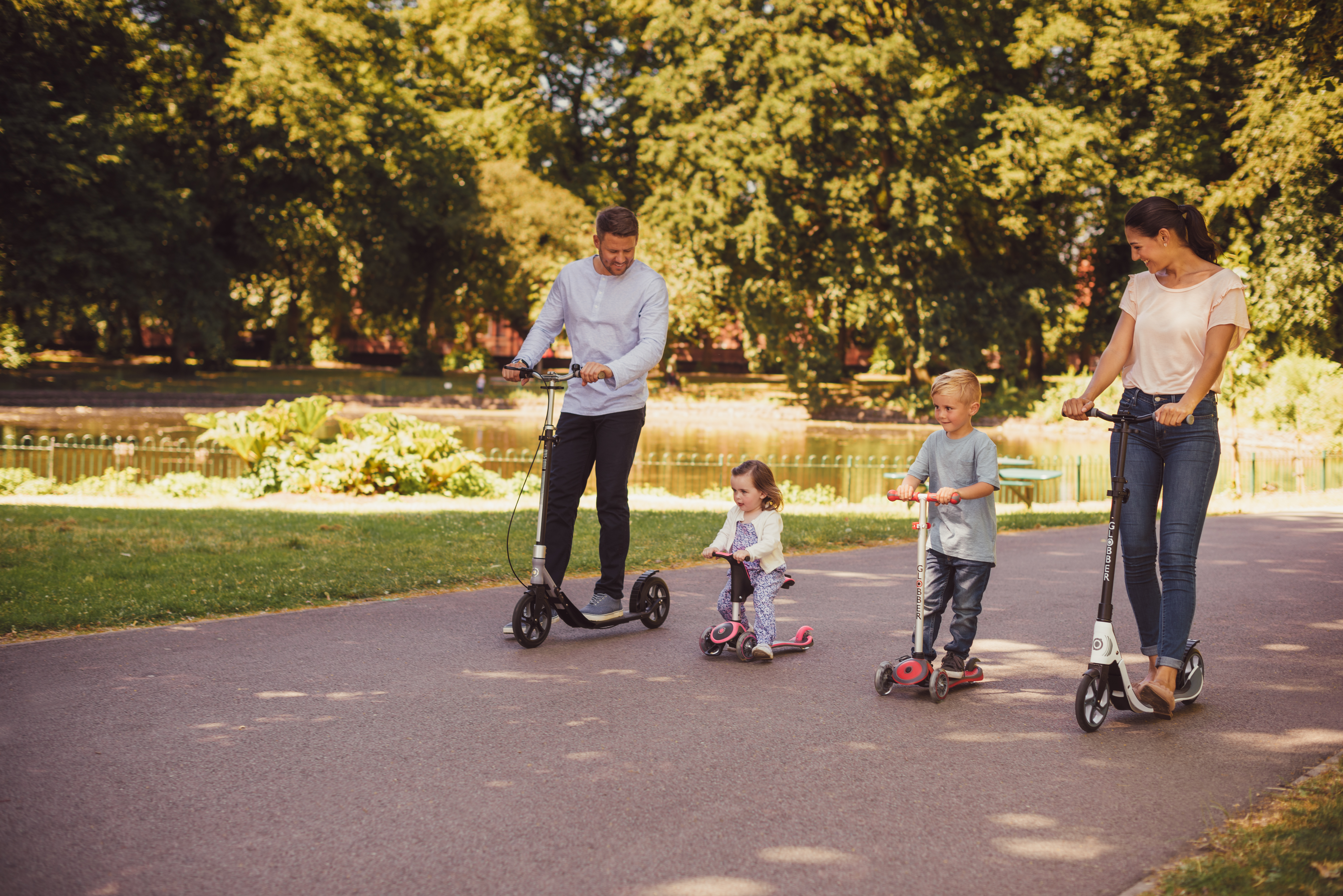 Family on Globber scooters for sustainable urban mobility