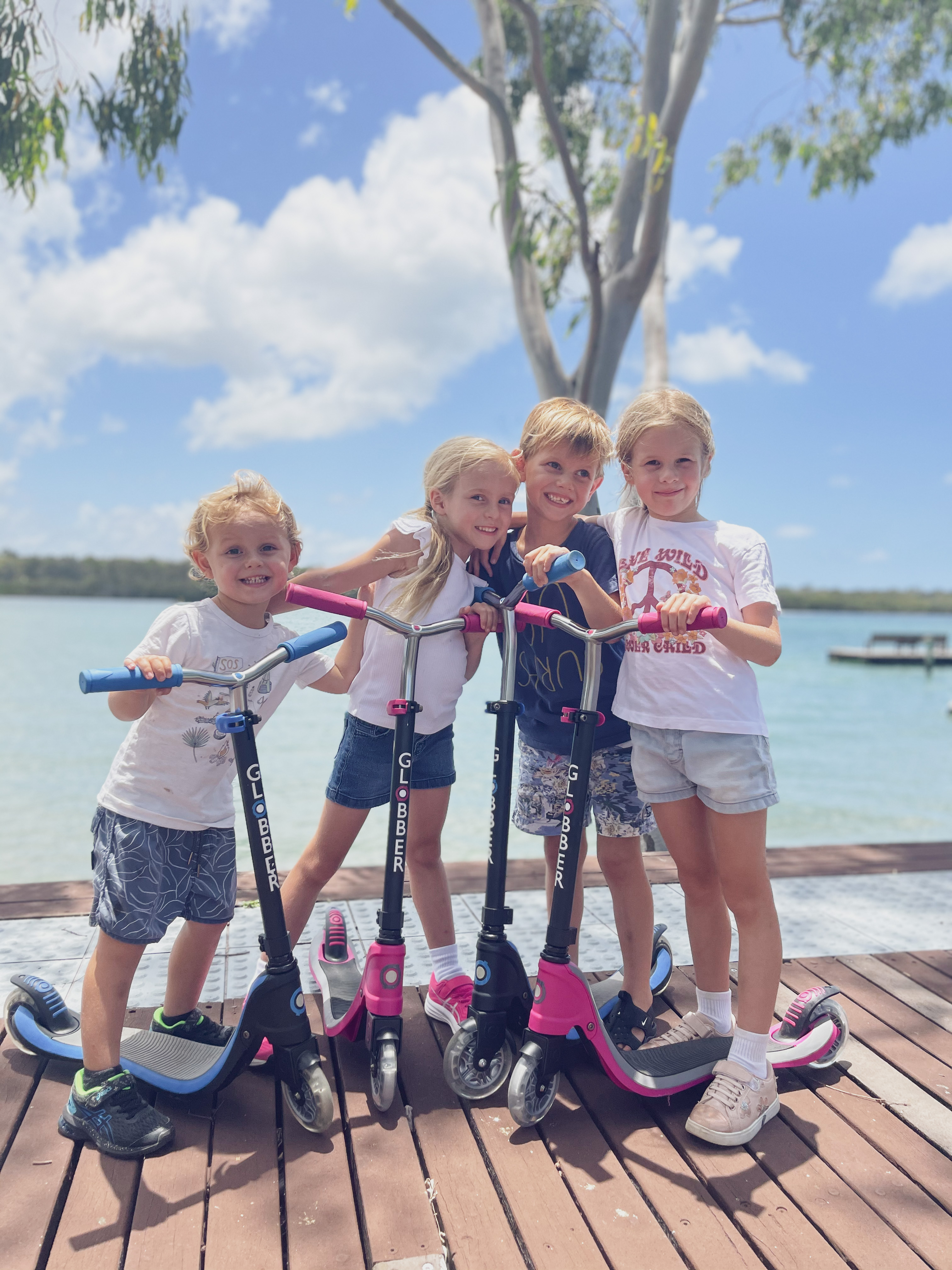 Globber kid crew with their FLOW series 2-wheel scooters for kids